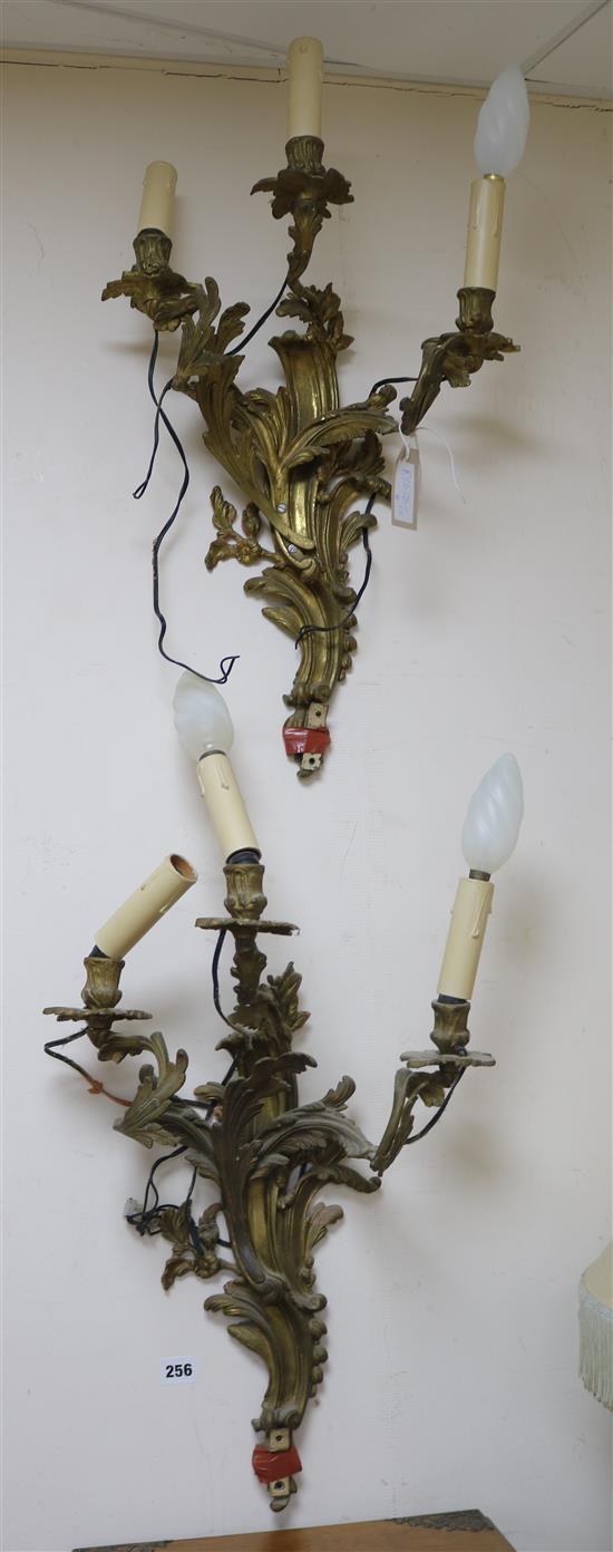 A pair of three branch ormolu wall lights length 55cm